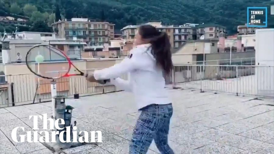 Pair play tennis between rooftops during coronavirus lockdown in Italy
